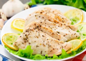 Simple And Perfect Lemon Garlic Chicken Served On A Plate With Lemon And Lettuce