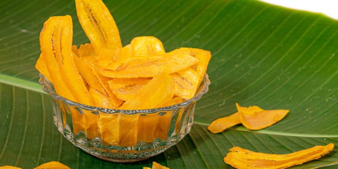 A Bowl Of Healthy Baked Banana Chips On A Banana Leaf