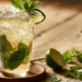 Fresh Mojito In A Tall Highball Glass With Packed Ice, Mint Sprig, And Lime Wheel On A Wooden Table